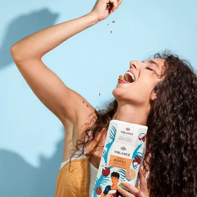 girl eating from coco choco muesli box